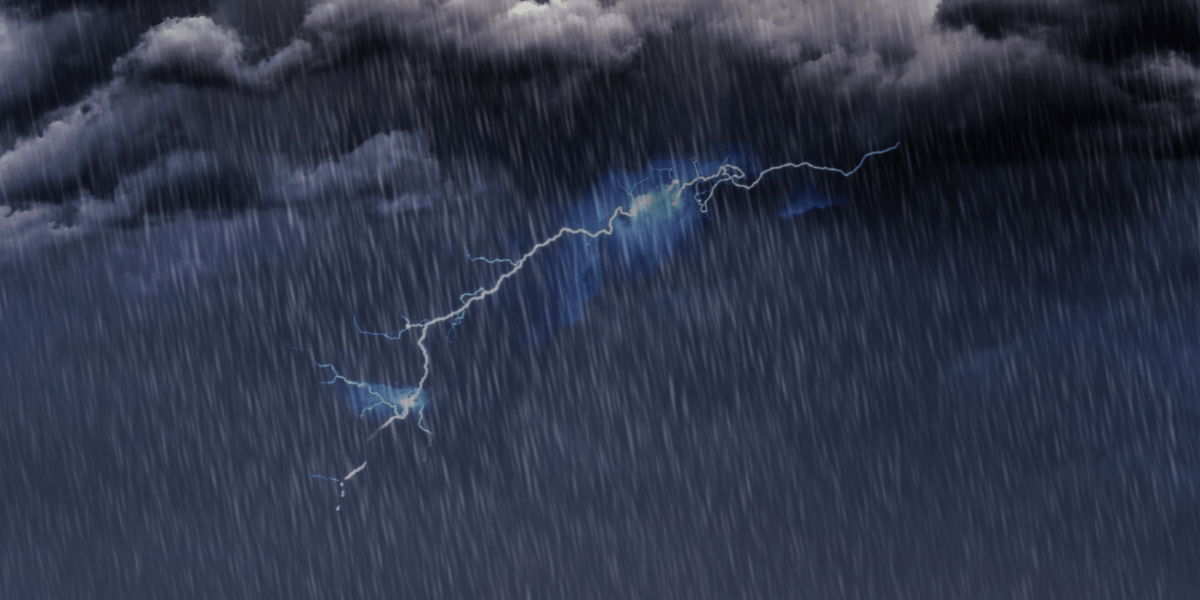 Lightning strikes amidst dark, stormy clouds and heavy rainfall