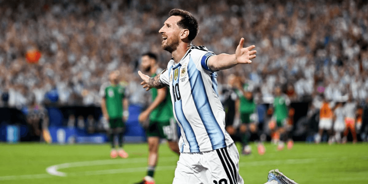 Football player celebrating a goal for Argentina in a packed stadium