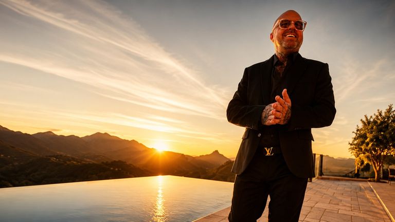 A suited man stands by a pool at sunset, symbolizing the rise of Brandon Johns and the "Brandon From Georgia" brand.