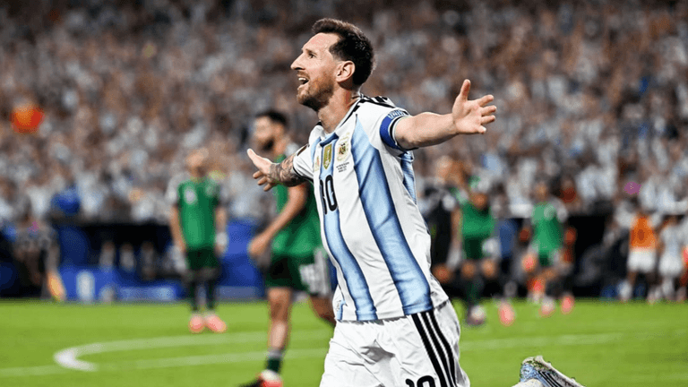 Football player celebrating a goal for Argentina in a packed stadium