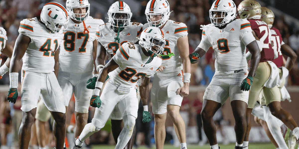 Football players in white jerseys celebrate during a game on the field