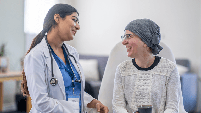 A doctor and patient share a warm conversation in a healthcare setting