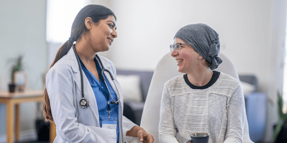 A doctor and patient share a warm conversation in a healthcare setting