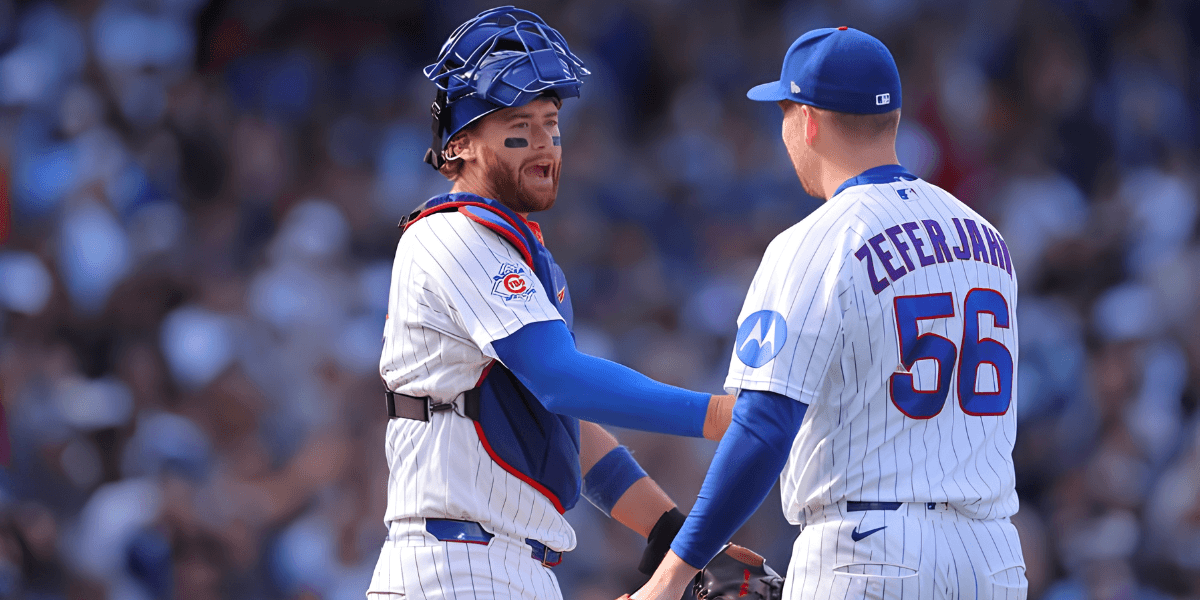 Two baseball players in team uniforms celebrating on the field during a game