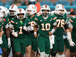 Football team in green uniforms running onto the field together during a game