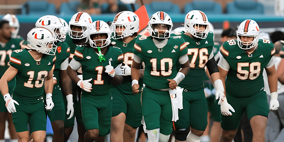 Football team in green uniforms running onto the field together during a game