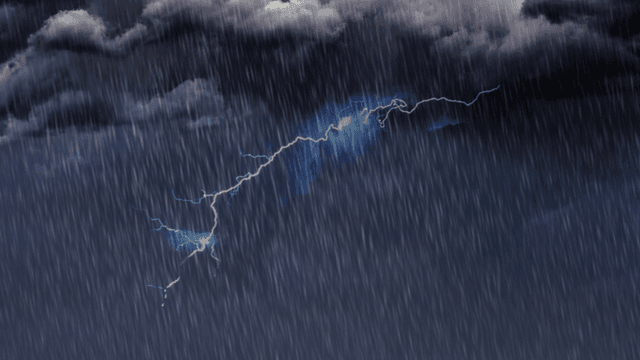 Lightning strikes amidst dark, stormy clouds and heavy rainfall