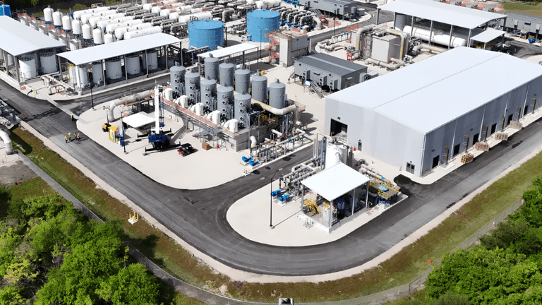 Aerial view of an industrial facility with large tanks and processing equipment