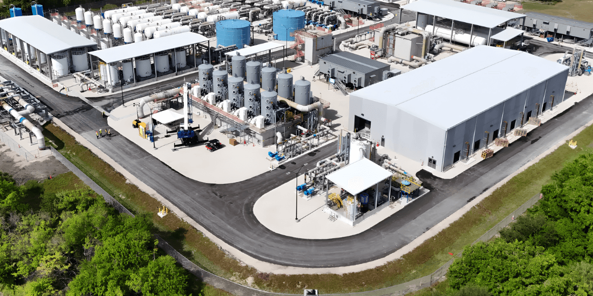 Aerial view of an industrial facility with large tanks and processing equipment