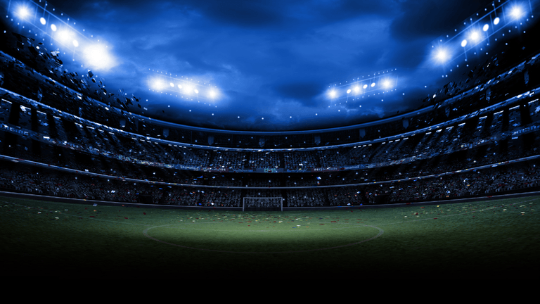 Illuminated soccer stadium under floodlights prepared for an international football match.