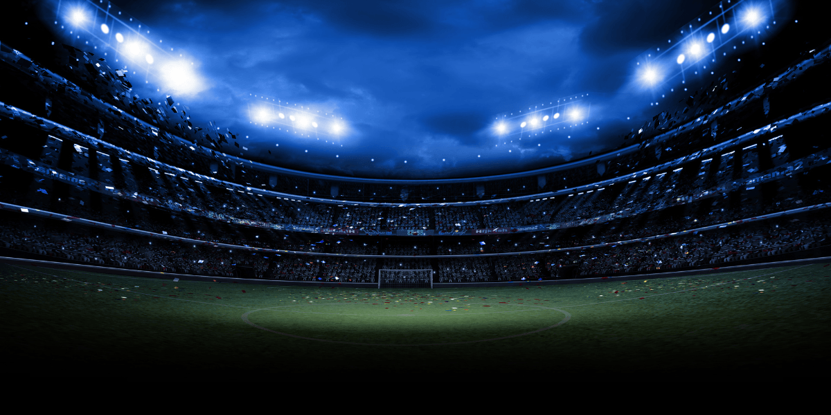 Illuminated soccer stadium under floodlights prepared for an international football match.