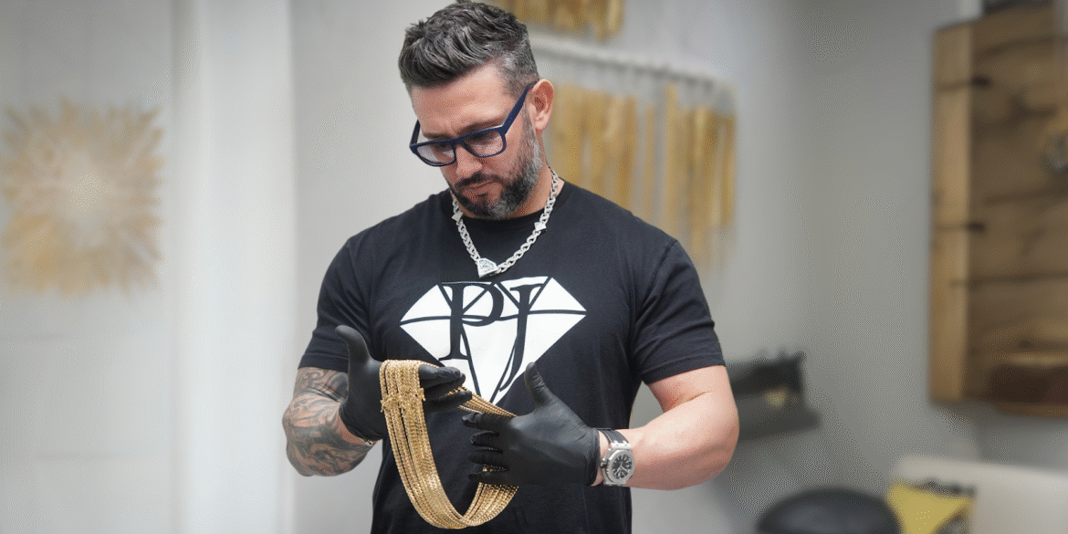 Rafael Perez, founder of Pochy Jewelry, inspects a gold Cuban link chain, symbolizing craftsmanship and innovation in Miami's jewelry industry.