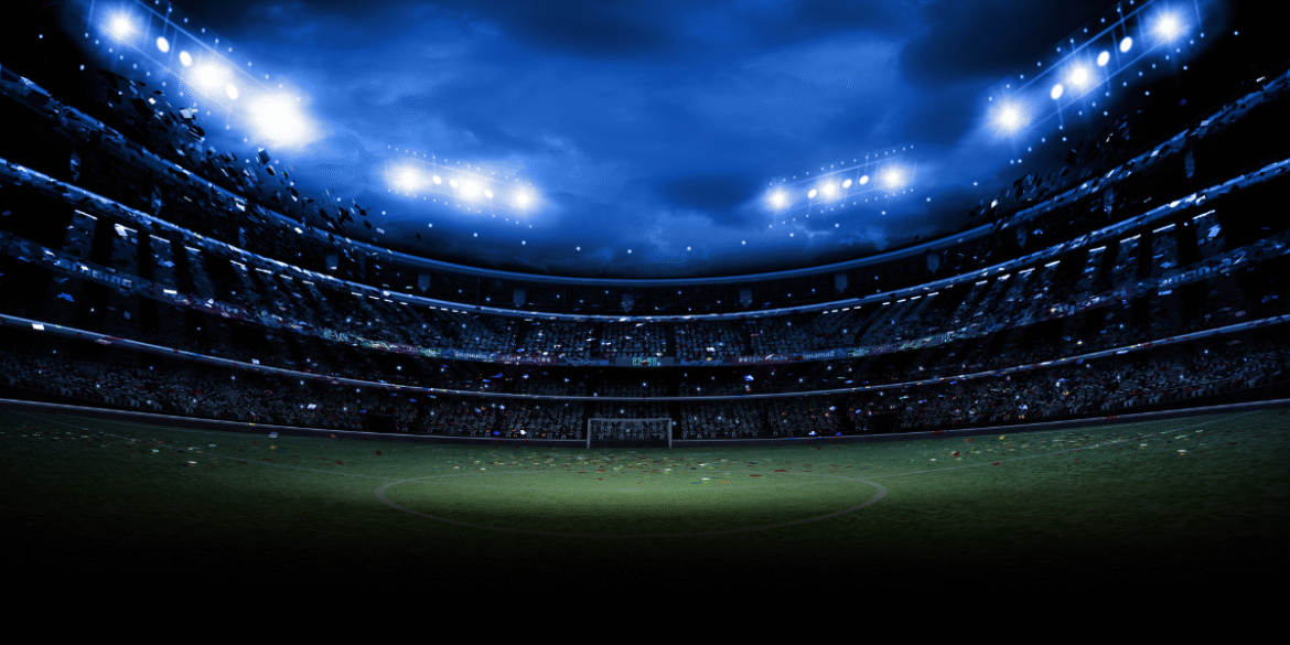 Illuminated soccer stadium under floodlights prepared for an international football match.