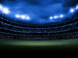 Illuminated soccer stadium under floodlights prepared for an international football match.
